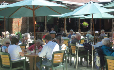 Summer cookouts are fun for residents and family members gathering in the back Porch Garden on a beautiful summer day