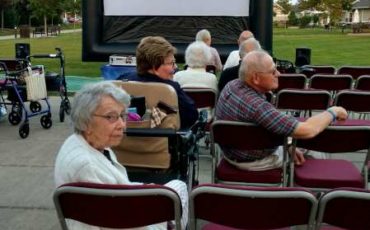 Waiting for the movie to begin on the Village Green
